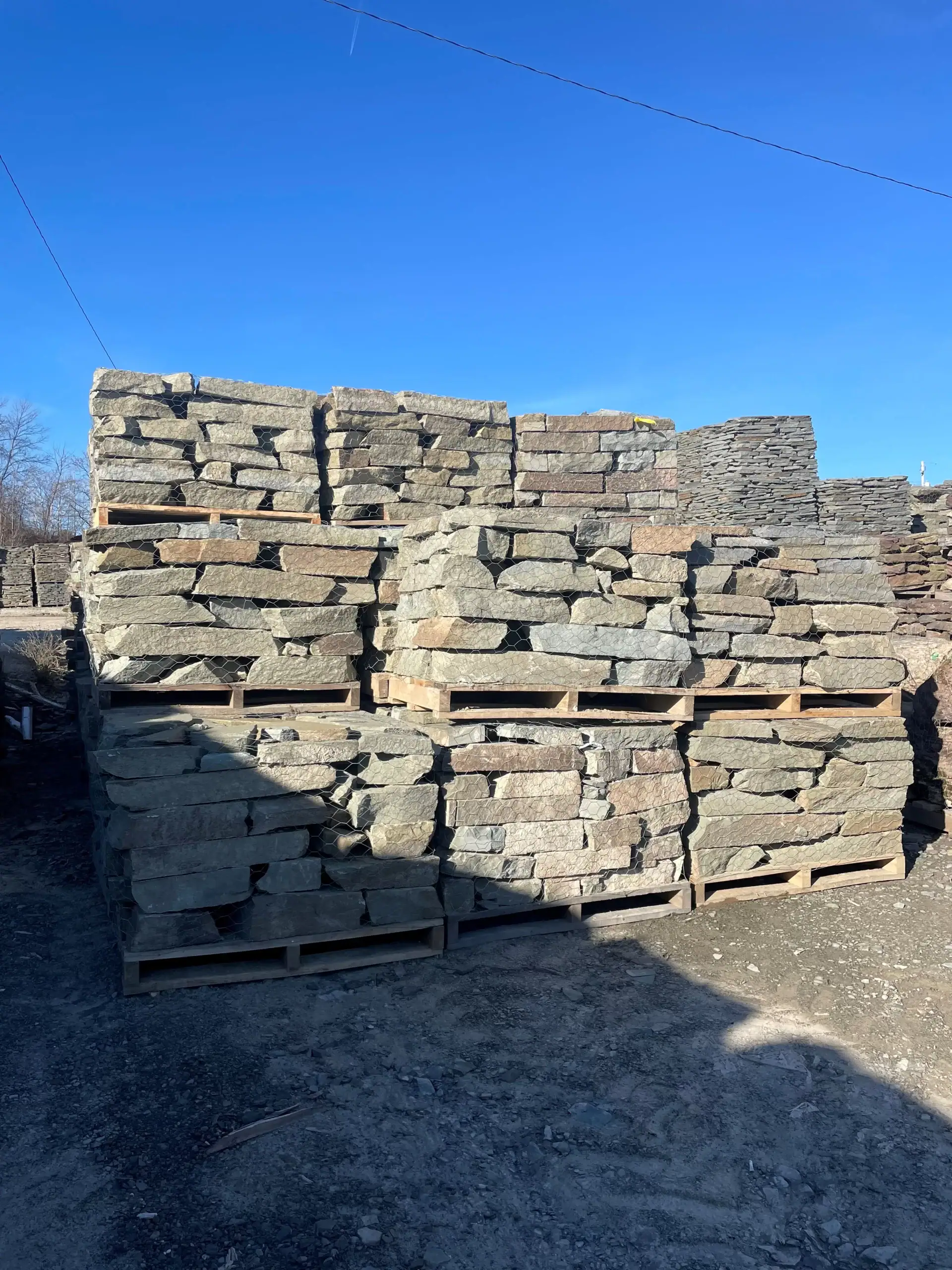 Green-brown Colonial home in Long Island, featuring a classic design with a blend of earthy tones, an ideal example of masonry craftsmanship from Power House Mason Supply